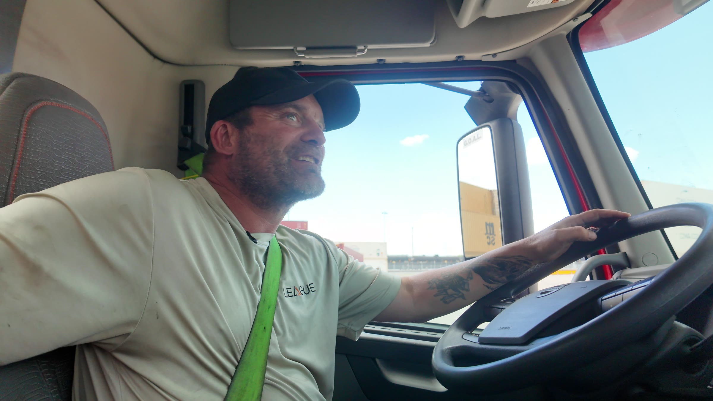 A League Trucking driver at the wheel, driving through the Port of Tampa container yard.