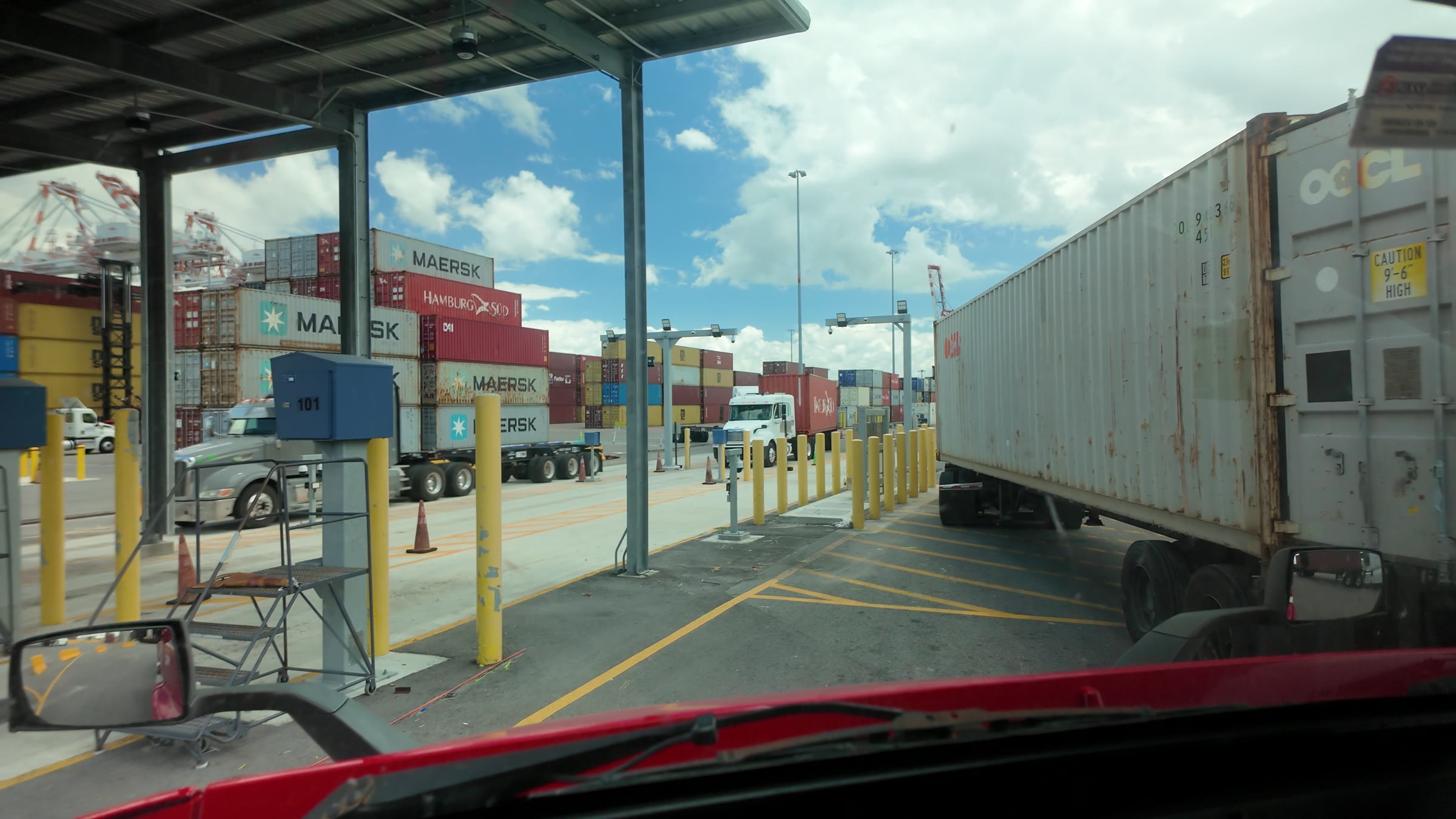 Trucks lined up at the gate lanes at the Port of Tampa, seen from the cab.