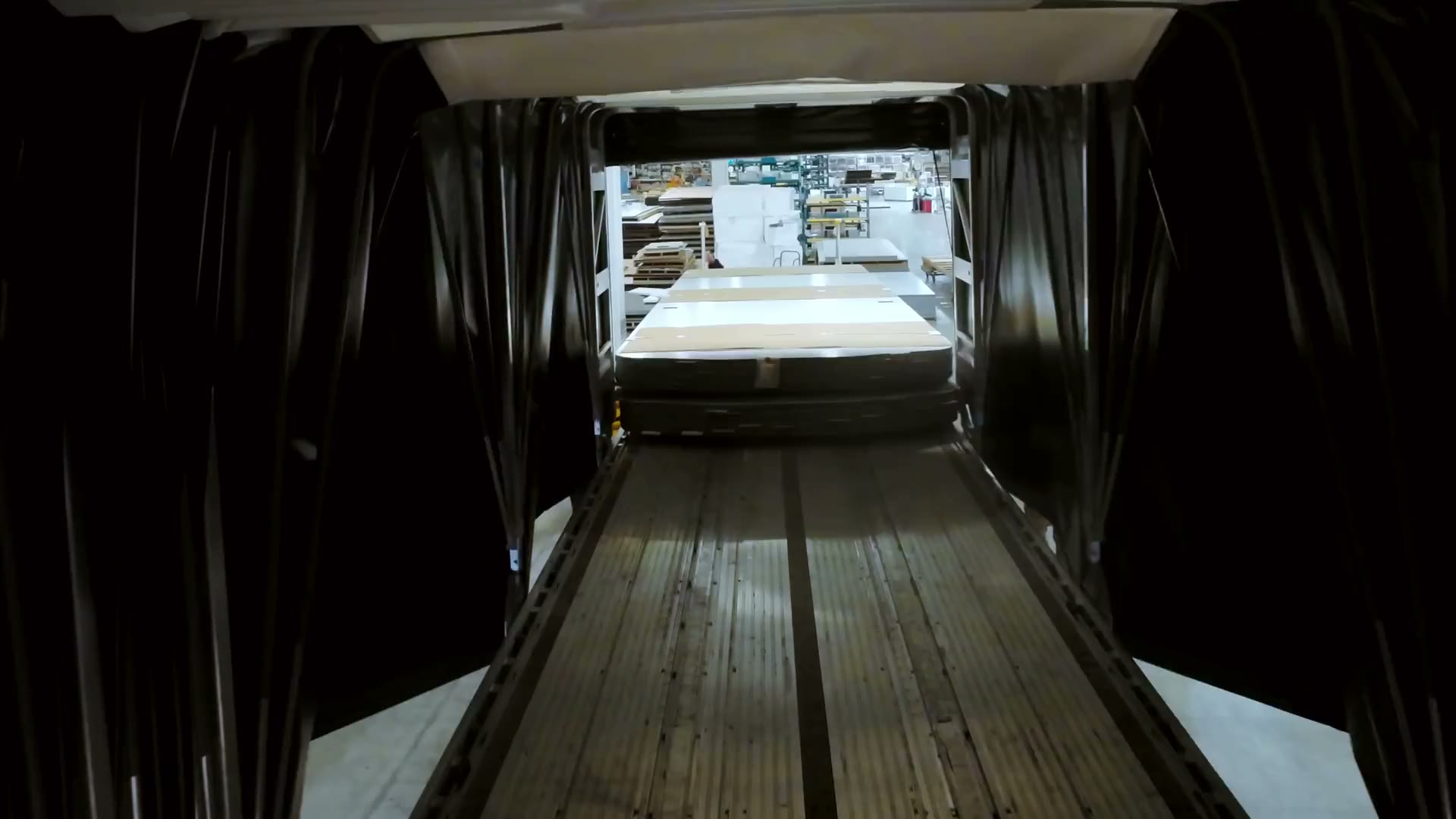 Inside the conestoga at the customer's warehouse, a forklift unloading the freight.
